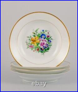 Bing & Grøndahl, four deep plates in porcelain with flowers and gold decoration