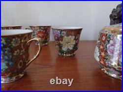 Vintage Porcelain tea cups and lidded sugar hand painted flowers gold china