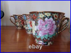 Vintage Porcelain tea cups and lidded sugar hand painted flowers gold china