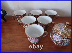 Vintage Porcelain tea cups and lidded sugar hand painted flowers gold china